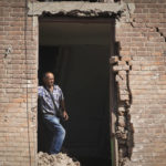 
              Local resident stands in a building destroyed during a missile strike in Kharkiv, Ukraine, Thursday, Aug. 18, 2022. (AP Photo/Andrii Marienko)
            