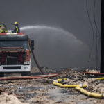 
              Firefighters work to put out a deadly fire at a large oil storage facility in Matanzas, Cuba, Tuesday, Aug. 9, 2022. The fire was triggered when lighting struck one of the facility's eight tanks late Friday, Aug. 5th. (Yamil Lage, Pool photo via AP)
            