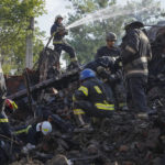 
              Firefighters dig through the rubble of a building destroyed during a missile strike in Kharkiv, Ukraine, Thursday, Aug. 18, 2022. (AP Photo/Andrii Marienko)
            