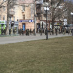 
              FILE - Russian troops stand in a street as people take part in a rally against the Russian occupation in Kherson, Ukraine, Monday, March 14, 2022. The southern city of Kherson was the first to fall to Russia's invasion. But Kherson remains at the heart of the conflict and Ukraine's efforts to save its vital access to the sea. (AP Photo/File)
            