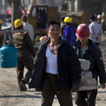
              FILE - North Korean construction workers carry building materials in the Mansudae area of Pyongyang, North Korea, Oct. 11, 2011. As the war in Ukraine stretches into its seventh month, North Korea is hinting at its interest in sending construction workers to help rebuild Russian-occupied territories in the country's east.(AP Photo/David Guttenfelder, File)
            