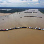 
              FILE - Dredging barges operated by illegal miners converge on the Madeira river, a tributary of the Amazon river, searching for gold, in Autazes, Amazonas state, Brazil, Nov. 25, 2021. Brazilians go to the polls in October, and they'll have a choice between reelecting Jair Bolsonaro, or bringing back former President Luiz Inácio Lula da Silva. Bolsonaro has allowed settlers to takeover public land and gold miners to move into indigenous territory. (AP Photo/Edmar Barros, File)
            