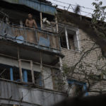 
              A man stands at the balcony of an apartment in a residential building that was damaged after a Russian attack in Kramatorsk, Ukraine, Wednesday, Aug. 31, 2022. (AP Photo/Leo Correa)
            