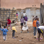 
              Children play ball games on a dirt street in the Kibera neighborhood of Nairobi, Kenya Sunday, Aug. 14, 2022. Kenyans attended regular church services on Sunday, at which many pastors preached a message of patience and peace, as the country continues to wait for the results of Tuesday's presidential election. (AP Photo/Ben Curtis)
            