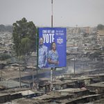 
              A billboard asking Kenyans to vote for Kenyan presidential candidate Raila Odinga, referred to affectionately as "Baba", the Swahili word for "father", and his running mate Martha Karua, rises above shacks in the low-income Mathare neighborhood of Nairobi, Kenya Friday, July 29, 2022. Kenya's Aug. 9 election is ripping open the scars of inequality and corruption as East Africa's economic hub chooses a successor to President Uhuru Kenyatta. (AP Photo/Brian Inganga)
            