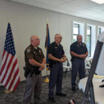 Col. John Bolduc, center, superintendent of Nebraska State Patrol, speaks to reporters at a press conference about the deaths of four people in Laurel, Neb., Friday, Aug. 5, 2022. Flanking him are Cedar County Sheriff Larry Koranda, left, and Troop B Capt. Dain Hicks of the state patrol. Police investigating the killings of four people in a small northeast Nebraska city have arrested a neighbor of the victims, the Nebraska State Patrol said Friday. (Riley Tolan-Keig/The Norfolk Daily News via AP)