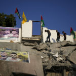 
              Palestinians clamber over the rubble of the house of Subhi Sbeihat after it was demolished by Israeli forces along with the house of Asad Rifai, both suspected of carrying out a deadly May 2022 attack on Israelis in the city of Elad, near Tel Aviv, in Rummana, near the West Bank city of Jenin, Monday, Aug. 8, 2022. The Israeli military says their soldiers faced a violent protest during the operation. (AP Photo/Majdi Mohammed)
            