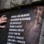 
              Mary Elledge, head of the greater Portland chapter of Parents of Murdered Children, looks at the name of her son, Rob, on a memorial in Oregon City, Ore., Wednesday, July 20, 2022. Elledge, whose son was murdered in 1986 and the case unresolved for months, is opposed to resources being taken from cold case units to address rising homicides. "The unsolved cases are where I see so much sadness," Elledge said of the families she works with. "When they don’t get an answer, it’s like nobody cares and they never find out what happened." (AP Photo/Craig Mitchelldyer)
            