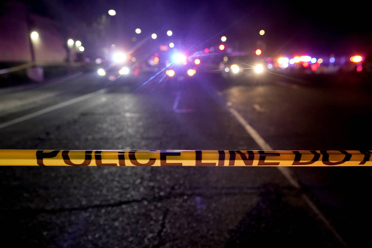 FILE - A police tape blocks a road near the scene where a Sacramento County Sheriff's deputy was sh...