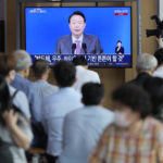 
              People watch a TV screen showing the live broadcast of South Korean President Yoon Suk Yeol's press conference, at the Seoul Railway Station in Seoul, South Korea, Wednesday, Aug. 17, 2022. Yoon said Wednesday his government has no plans to pursue its own nuclear deterrent in the face of growing North Korean nuclear threats, as he urged the North to return to dialogue aimed at exchanging denuclearization steps for economic benefits. (AP Photo/Lee Jin-man)
            