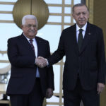 
              Turkey's President Recep Tayyip Erdogan, right, and Palestinian President Mahmoud Abbas shake hands during a welcome ceremony in Ankara, Turkey, Tuesday, Aug. 23, 2022. Abbas in Turkey for a two-day state visit. (AP Photo/Burhan Ozbilici)
            