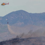 
              A helicopter drops water during a wildfire extinction work near Alcublas, eastern Spain, on Thursday, Aug. 18, 2022. The European Forest Fire Information System says 275,000 hectares (679,000 acres) have burned in wildfires so far this year in Spain. That's more than four times the country's annual average of 67,000 hectares (165,000 acres) since 2006, when records began. (AP Photo/Alberto Saiz)
            