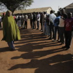 
              People line up to cast their vote in Kenya's general election in Sugoi, 50 kms (35 miles) north west of Eldoret, Kenya, Tuesday Aug. 9, 2022. Kenyans are voting to choose between opposition leader Raila Odinga Deputy President William Ruto to succeed President Uhuru Kenyatta after a decade in power. (AP Photo/Brian Inganga)
            