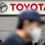 
              A man walks past a Toyota dealer in Tokyo on May 11, 2022. Toyota Motor Corp. reported Thursday, Aug. 4, 2022 a quarterly profit of 736.8 billion yen ($5.5 billion), down from 897.8 billion yen the previous year. (AP Photo/Eugene Hoshiko)
            