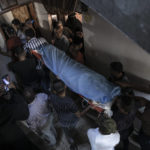 
              Mourners carry the body of 11-year-old Layan al-Shaer during her funeral in Khan Younis, in the Gaza Strip, Thursday, Aug. 11, 2022. On Thursday, Layan died of her wounds after she was injured in last week's Israeli air strikes, bringing the Palestinian death toll in fighting between Israel and Gaza militants to 48. (AP Photo/Fatima Shbair)
            