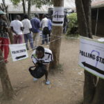 
              People line up to cast their vote in Kenya's general election in Eldoret, Kenya, Tuesday Aug. 9, 2022. Kenyans are voting Tuesday in an unusual presidential election, where a longtime opposition leader who is backed by the outgoing president faces the brash deputy president who styles himself as the outsider and a “hustler.” (AP Photo/Brian Inganga)
            