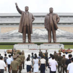 
              Citizens visit the statues of President Kim Il Sung and Chairman Kim Jong Il on Mansu Hill to commemorate the 77th anniversary of Korea's Liberation in Pyongyang, North Korea, Monday, Aug. 15, 2022. (AP Photo/Cha Song Ho)
            
