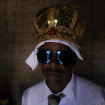 
              Adonildes da Cunha receives his Emperor's crown in the Kalunga quilombo, during the culmination of the week-long pilgrimage and celebration for the patron saint "Nossa Senhora da Abadia" or Our Lady of Abadia, in the rural area of Cavalcante in Goias state, Brazil, Monday, Aug. 15, 2022. Devotees, who are the descendants of runaway slaves, celebrate Our Lady of Abadia at this time of the year with weddings, baptisms and by crowning distinguished community members, as they maintain cultural practices originating from Africa that mix with Catholic traditions. (AP Photo/Eraldo Peres)
            