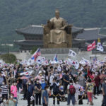 
              People stage a rally against North Korea on Korea's Liberation Day in front of the statue of King Sejong in the Joseon Dynasty, in Seoul, South Korea, Monday, Aug. 15, 2022. South Korean President Yoon Suk Yeol on Monday offered "audacious" economic assistance to North Korea if it abandons its nuclear weapons program while avoiding harsh criticism of the North days after it threatened "deadly" retaliation over the COVID-19 outbreak it blames on the South. (AP Photo/Ahn Young-joon)
            