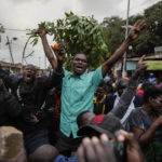 
              Kenyan opposition leader Raila Odinga supporters celebrate developments at the electoral commission in the Kibera neighborhood of Nairobi, Kenya, Monday, Aug. 15, 2022, as the country continues to wait for the results of the presidential election in which Kenyans chose between Odinga and Deputy President William Ruto to succeed President Uhuru Kenyatta after a decade in power. (AP Photo/Ben Curtis)
            