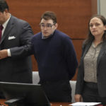 
              Marjory Stoneman Douglas High School shooter Nikolas Cruz stands with members of his defense team during the penalty phase of Cruz's trial at the Broward County Courthouse in Fort Lauderdale on Thursday, Aug. 4, 2022. Cruz previously plead guilty to all 17 counts of premeditated murder and 17 counts of attempted murder in the 2018 shootings. (Amy Beth Bennett/South Florida Sun Sentinel via AP, Pool)
            