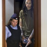 
              WNBA star and two-time Olympic gold medalist Brittney Griner is escorted in a courtroom for a hearing, in Khimki just outside Moscow, Russia, Tuesday, Aug. 2, 2022. Since Brittney Griner last appeared in her trial for cannabis possession, the question of her fate expanded from a tiny and cramped courtroom on Moscow's outskirts to the highest level of Russia-US diplomacy. (Evgenia Novozhenina/Pool Photo via AP)
            