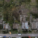 
              A crater from a Russian rocket attack Friday night is seen next to damaged homes in Kramatorsk, Donetsk region, eastern Ukraine, Saturday, Aug. 13, 2022. The strike killed three people and wounded 13, according to the mayor. The attack came less than a day after 11 other rockets were fired at the city, one of the two main Ukrainian-held ones in Donetsk province, the focus of an ongoing Russian offensive to capture eastern Ukraine's Donbas region. (AP Photo/David Goldman)
            
