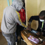 
              People line up to vote at the Moi avenue Primary School in Nairobi, Kenya, Tuesday, Aug. 9, 2022. Polls opened Tuesday in Kenya's unusual presidential election, where a longtime opposition leader who is backed by the outgoing president faces the deputy president who styles himself as the outsider. (AP Photo/Khalil Senosi)
            