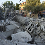 
              Palestinians look at rubble of the house of Asad Rifai after it was demolished by Israeli forces along with the house of of Subhi Sbeihat, both suspected of carrying out a deadly May 2022 attack on Israelis in the city of Elad, near Tel Aviv, in Rummana, near the West Bank city of Jenin, Monday, Aug. 8, 2022. The Israeli military says their soldiers faced a violent protest during the operation. (AP Photo/Majdi Mohammed)
            