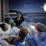
              A midwife tends to Angela Quintana Aucapan and her newborn son, Namunkura, as the child’s father, Cristian Fernandez Ancapan, and Ingrid Naipallan, a machi, or spiritual guide, assist at the San Jose de Osorno Base Hospital in Osorno, Chile, Saturday, Aug. 20, 2022. Reclaiming ancestral practices is what drew Quintana Aucapan to have her baby in the special delivery room. (AP Photo/Luis Hidalgo)
            