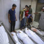 
              CAPTION CORRECTION - CORRECTS TO SIX PALESTINIANS INCLUDING CHILDREN NOT SIX CHILDREN - Mourners pray over the bodies of six Palestinians including children killed in an explosion in Jebaliya refugee camp, at the hospital morgue in Jebaliya, northern Gaza Strip, Saturday, Aug. 6, 2022. On Saturday, a projectile hit in Jebaliya, killing the six. Palestinians held Israel responsible, while Israel said it was investigating whether the area was hit by an errant rocket. (AP Photo/Abdel Kareem Hana)
            