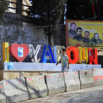 
              A Lebanese youth walks next to portraits of killed Hezbollah fighters in the Lebanese-Israeli border village of Yaroun, south Lebanon, Saturday, Aug. 13, 2022, where the parents of Hadi Matar emigrated from. On Friday, Matar, 24, born in Fairview, N.J., attacked author Salman Rushdie during a lecture in New York. His birth was a decade after "The Satanic Verses" was first published. (AP Photo/Mohammed Zaatari)
            