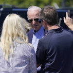 President Joe Biden and first lady Jill Biden are greeted by Kentucky Gov. Andy Beshear, right, and his wife Britainy Beshear, as they arrive at Wendell H. Ford Airport Landing Zone, Monday, Aug. 8, 2022, in Chavies, Ky (AP Photo/Evan Vucci)