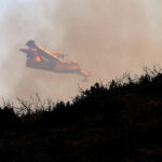 
              A firefighting airplane flies over a wildfire near Alcublas, eastern Spain, on Thursday, Aug. 18, 2022. The European Forest Fire Information System says 275,000 hectares (679,000 acres) have burned in wildfires so far this year in Spain. That's more than four times the country's annual average of 67,000 hectares (165,000 acres) since 2006, when records began. (AP Photo/Alberto Saiz)
            