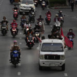 
              Anti-government protesters ride on motorcycle during a protest in Bangkok, Thailand, Wednesday, Aug. 24, 2022. Thailand's Constitutional Court ruled Wednesday that Prime Minister Prayuth Chan-ocha must suspend his active duties while the court decides whether he has overstayed his legal term in office. (AP Photo/Sakchai Lalit)
            