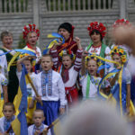 
              Members of a local community center wear traditional Ukrainian clothing to record an online video message for the country's upcoming Independence Day on Aug. 24 in Andriivka, Donetsk region, eastern Ukraine, Friday, Aug. 19, 2022. (AP Photo/David Goldman)
            