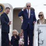
              President Joe Biden, center, returns a salute as he is joined by, from left, son Hunter Biden, grandson Beau Biden, first lady Jill Biden, obscured, and daughter-in-law Melissa Cohen, as they stand at the top of the steps of Air Force One at Andrews Air Force Base, Md., Wednesday, Aug. 10, 2022. They are heading to South Carolina for a week-long vacation on Kiawah Island. (AP Photo/Susan Walsh)
            