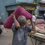 
              A porter carries a sacks of imported onions at a market place in Colombo, Sri Lanka, Friday, July 29, 2022. (AP Photo/Eranga Jayawardena)
            
