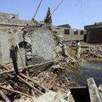 
              A family look for salvageable belongings from the remains of their flood-hit home in Shikarpur district of Sindh province, of Pakistan, Wednesday, Aug. 31, 2022. Officials in Pakistan raised concerns Wednesday over the spread of waterborne diseases among thousands of flood victims as flood waters from powerful monsoon rains began to recede in many parts of the country. (AP Photo/Fareed Khan)
            