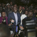 
              Deputy President and presidential candidate William Ruto, center, speaks to reporters after casting his vote in Kenya's general election in Sugoi, 50 kms (35 miles) north west of Eldoret, Kenya, Tuesday Aug. 9, 2022. Kenyans are voting to choose between opposition leader Raila Odinga and Ruto to succeed President Uhuru Kenyatta after a decade in power. (AP Photo/Brian Inganga)
            