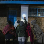
              People use a flash light to check voters registration lists as they line up to vote at the Kibera primary school in Nairobi, Kenya, Tuesday Aug. 9, 2022. Kenyans are voting to choose between opposition leader Raila Odinga and Deputy President William Ruto to succeed President Uhuru Kenyatta after a decade in power. (AP Photo/Mosa'ab Elshamy)
            