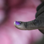 
              A man displays his inked finger after casting his ballots inside a polling station at the Kibera Primary School in Nairobi, Kenya, Tuesday, Aug. 9, 2022. Polls opened Tuesday in Kenya's unusual presidential election, where a longtime opposition leader who is backed by the outgoing president faces the deputy president who styles himself as the outsider. (AP Photo/Mosa'ab Elshamy)
            