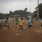 
              Boys play soccer in the neighborhood of Kibera, in Nairobi, Kenya, Tuesday, Aug. 16, 2022. Kenya is calm a day after Deputy President William Ruto was declared the winner of the narrow presidential election over longtime opposition figure Raila Odinga. (AP Photo/Mosa'ab Elshamy)
            