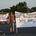 
              Local residents march to protest against the presence of hundreds of migrants who seek shelter outside an overcrowded asylum seekers center in Ter Apel, northern Netherlands, Thursday, Aug. 25, 2022. Banners read : "Real Refugees OK, Troublemakers Go Away" and "Enough of the Nuisance". (AP Photo/Peter Dejong)
            