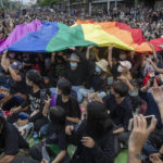 
              FILE - Pro-democracy activities display a LGBT flag during a protest at Democracy Monument in Bangkok, Thailand, Sunday, Aug, 16, 2020. Singapore’s announcement Sunday, Aug. 22, 2022, that it would decriminalize sex between men is being hailed as a step in the right direction for LGBTQ rights in the Asia-Pacific region, a vast area of nearly 5 billion people with different laws and attitudes. (AP Photo/Gemunu Amarasinghe, File)
            