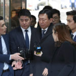 
              FILE - Lotte group Chairman Shin Dong-bin, center, is questioned by reporters upon arrival for his corruption trial at Seoul Central District Court in Seoul, South Korea, Dec. 22, 2017. South Korea's president will formally pardon Samsung heir Lee Jae-yong, one year after he was released on parole from a prison sentence for bribing former President Park Geun-hye as part of the massive corruption scandal that toppled Park's government, the justice minister announced Friday, Aug. 12, 2022. Shin and two other top business leaders will be pardoned as well, extending South Korea’s history of leniency toward convicted business tycoons and major white-collar crimes. (AP Photo/Lee Jin-man, File)
            