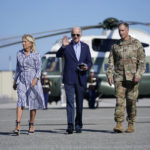 President Joe Biden and first lady Jill Biden, walk to board Air Force One for a trip to Kentucky to view flood damage, Monday, Aug. 8, 2022, in Dover Air Force Base, Del. (AP Photo/Evan Vucci)