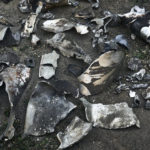 
              Fragments of ammunition placed on the ground by Ukrainian police investigators after a rocket attack in Kramatorsk, eastern Ukraine, Wednesday, Aug. 31, 2022. (AP Photo/Kostiantyn Liberov)
            