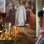 
              A parishioner lights a candle on the annual holiday of the Apple Feast of the Saviour at Saint-Strytensky Temple of the Orthodox Church of Ukraine, in Kostiantynivka, Donetsk region, eastern Ukraine, Friday, Aug. 19, 2022. (AP Photo/David Goldman)
            