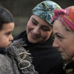 
              Pamela Vergara and son Julian Lagos Vergara sit with Mapuche cultural liaison Cristina Aron next to a tree that was planted over the placenta from Julian´s birth in Osorno, Chile, Sunday, Aug. 21, 2022. Chilean law now requires hospitals to give placentas to mothers if requested. (AP Photo/Luis Hidalgo)
            